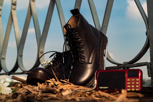 Close-up of black boots and vintage radio
