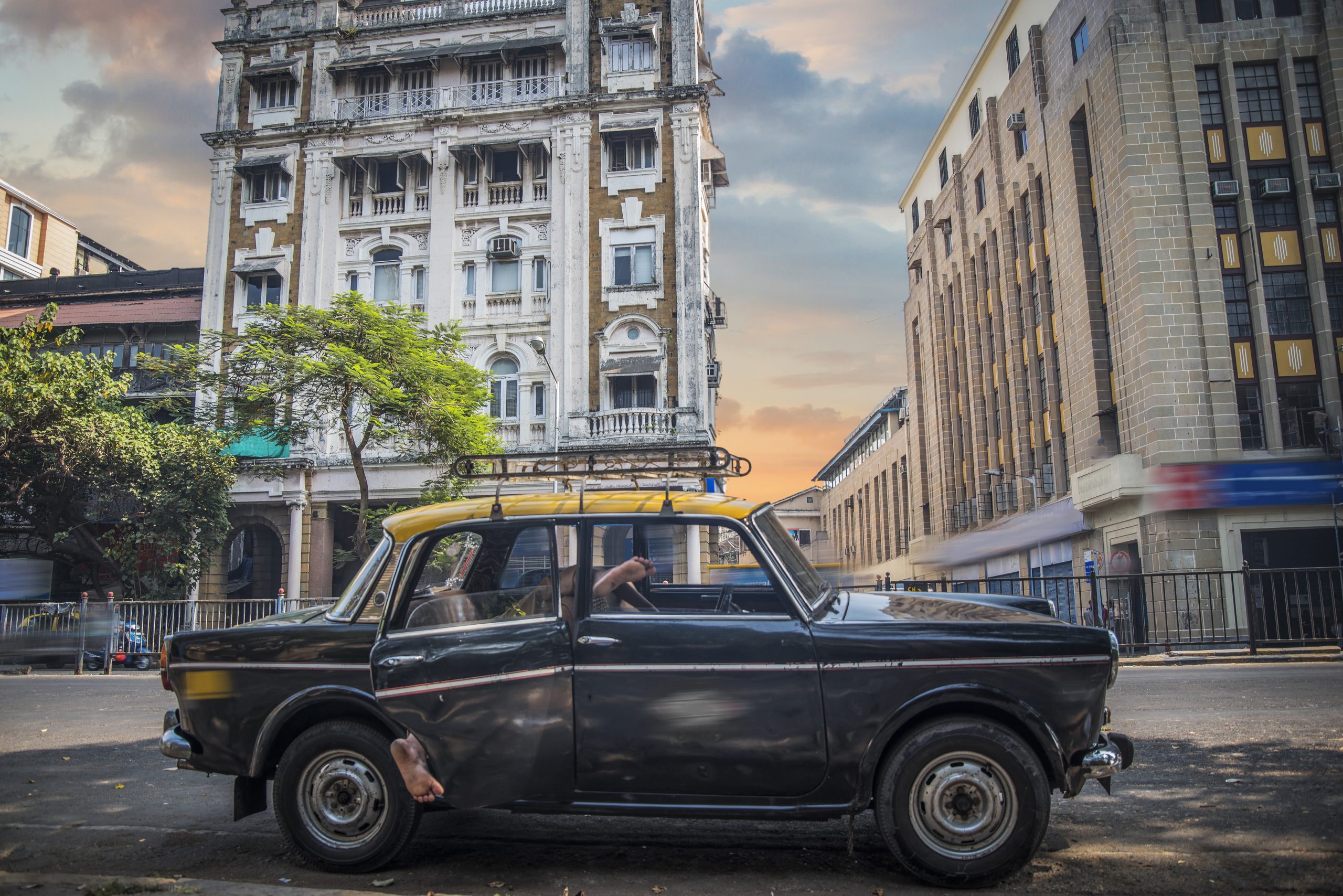 Mumbai taxi on the city street on the background of houses