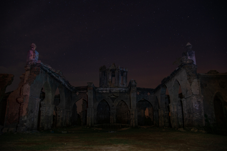 Front view of Shettihalli Rosary Church in ruins, shot at night, Hassan, Karnataka, India