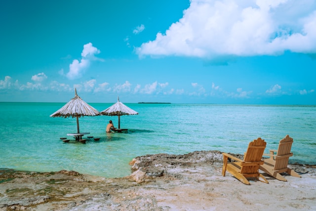 A palapa at sunrise on the end of a pier in Placencia, Belize, best adventure trips for couples