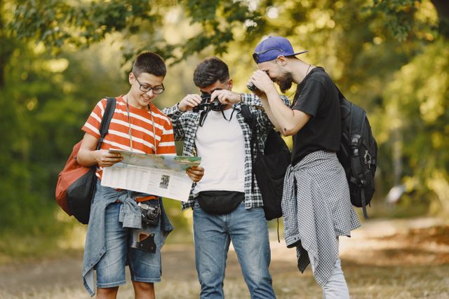 Three young men hiking and exploring a forest.