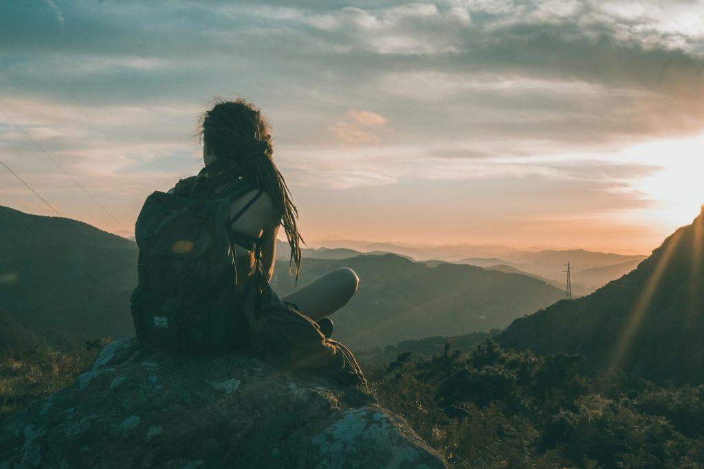 young woman backpacker trekking at the himalaya mountains