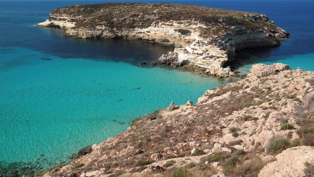 Comino Island view of a bay with turqouise water , and cliffs - Malta