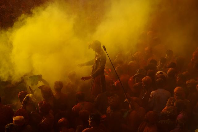 Revelers throw colored powder and spray each other with water at Banke Bihari Temple in Vrindavan.