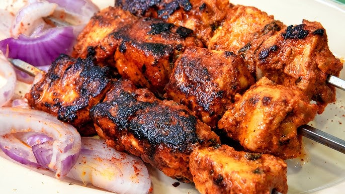 Boneless chicken pieces are marinated and cooked on coal.