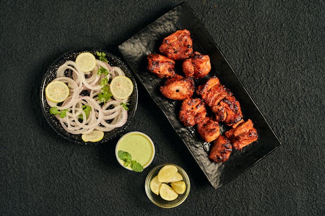 Boneless chicken pieces are marinated and cooked on coal.