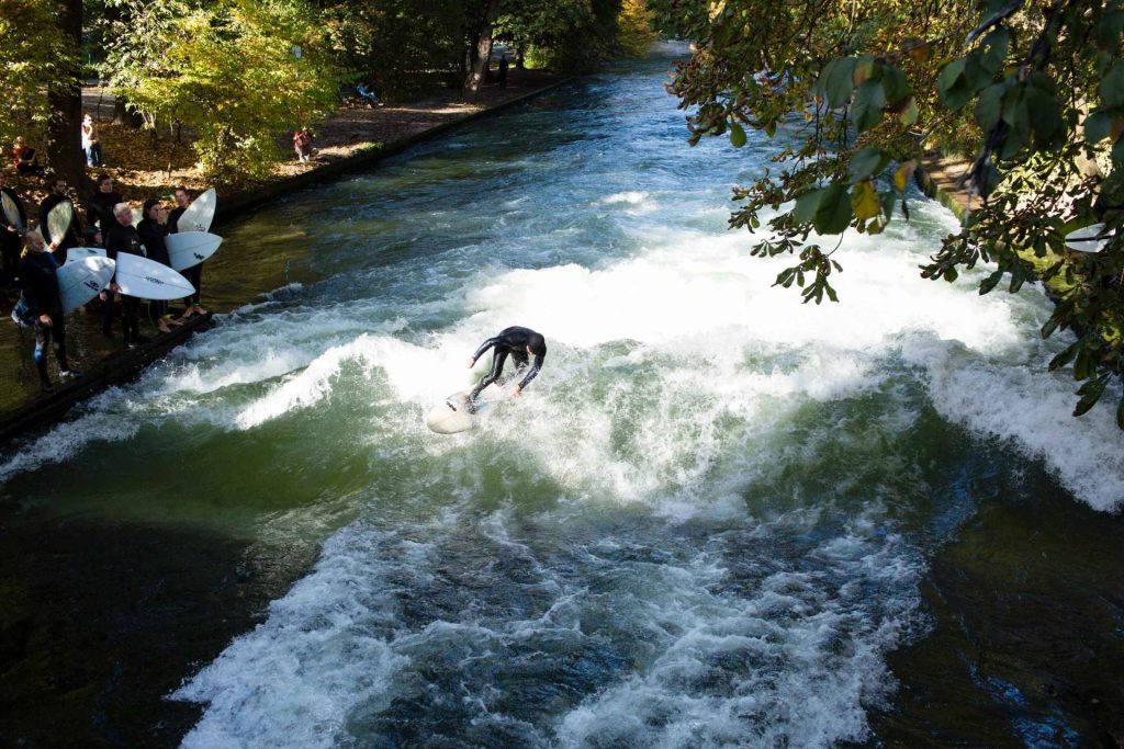 surfers may be seen getting ready and hitting the waves 