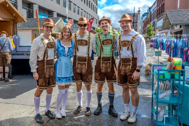 A group of adults in traditional German festival clothing