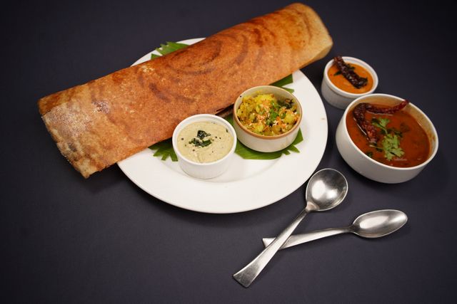 Mysore Masala Dosa is famous and is served with sambar and chutney,
