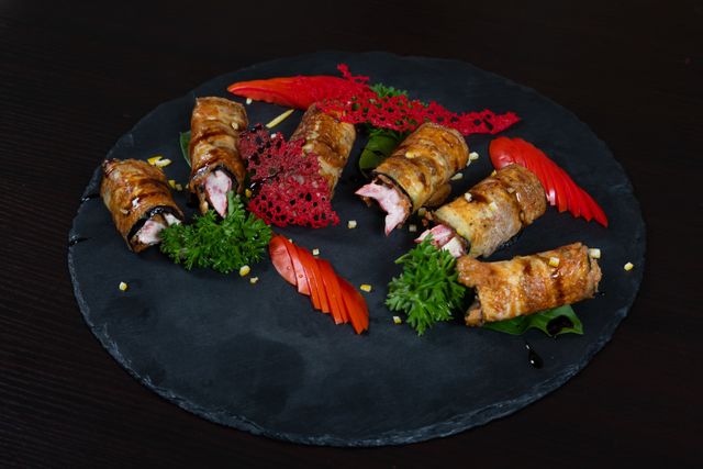 Thin strips of fried eggplants are stuffed and rolled