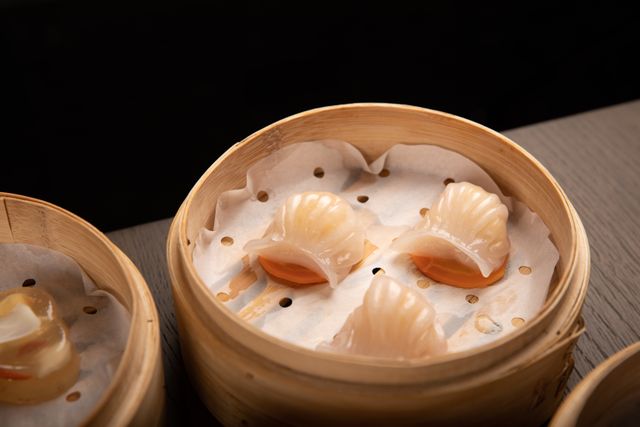 steamed dim sum dumplings in a traditional bamboo basket