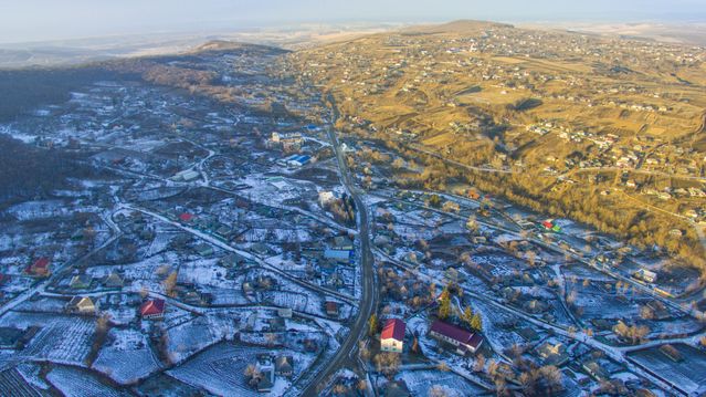 aerial view of a town surrounded by snowy countryside